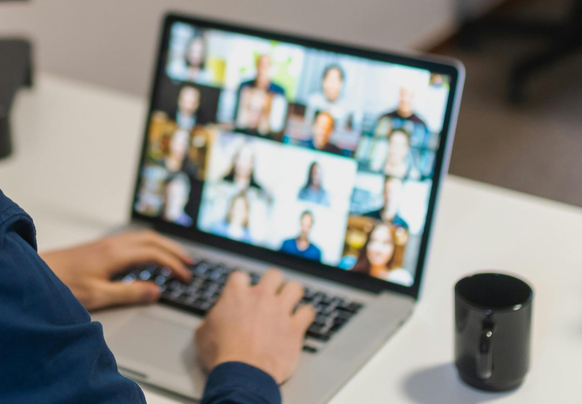 man typing during video call